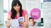 Woman in Singapore reading a booklet of IELTS sample test questions