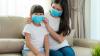 Mother and daughter wearing surgical masks